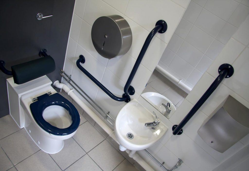 Disabled toilet with slip resistant floor tiles.