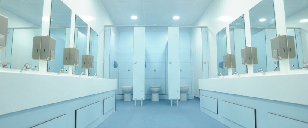 Interior wide shot of a school bathroom.