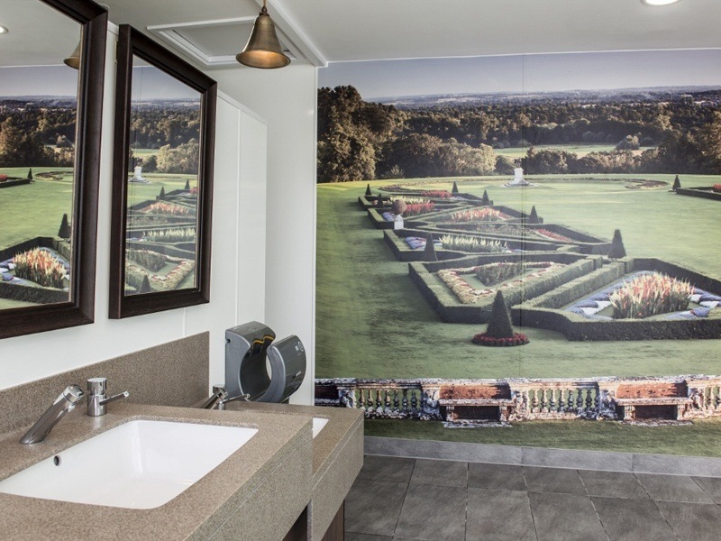 Washroom inside Clivedon House with a photographic wallpaper.