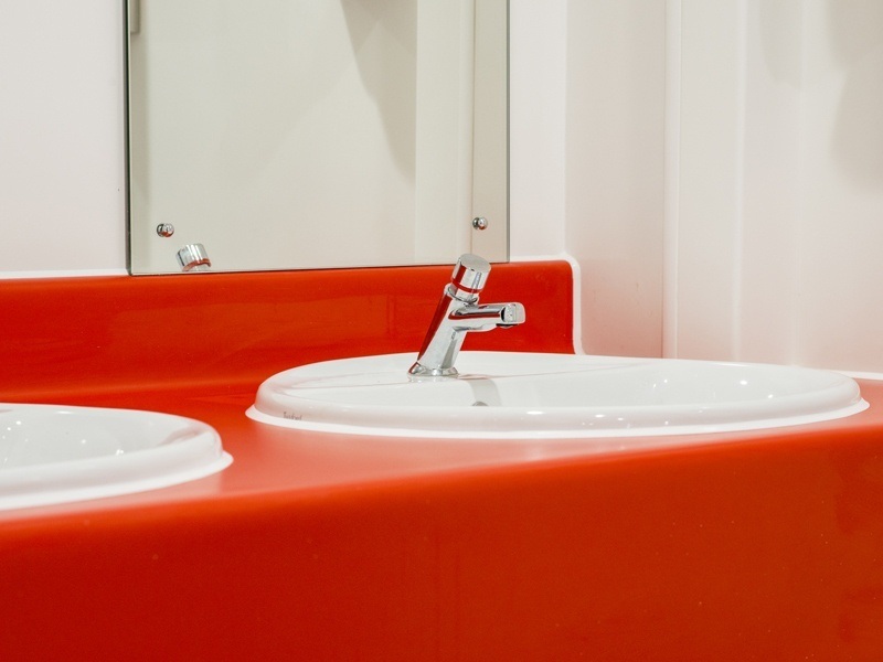 Two sinks on a red sink block.