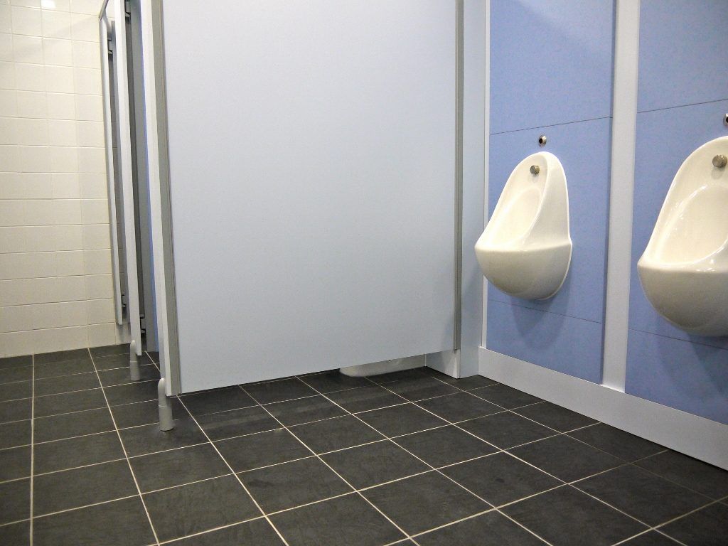 Two urinals in a school bathroom.