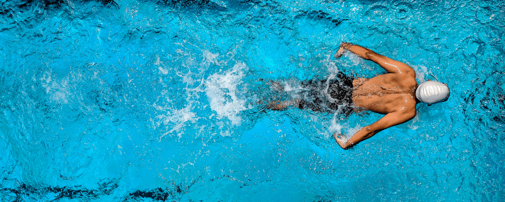 Overhead photo of a man swimming in a pool.
