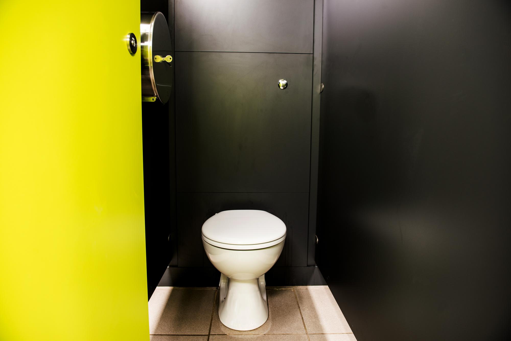 Toilet cubicle inside a theme park toilet room.
