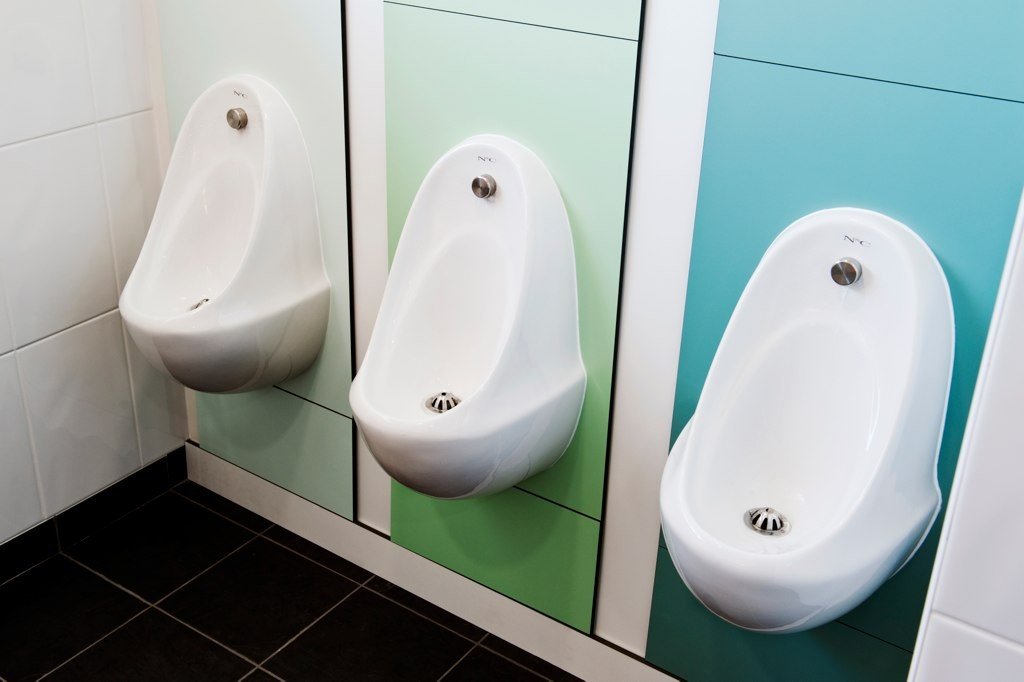 Photo of three urinals.