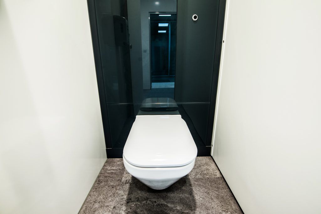 A new toilet inside an executive office bathroom.