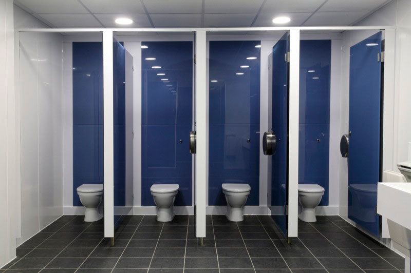 Four toilet cubicles inside an executive bathroom.