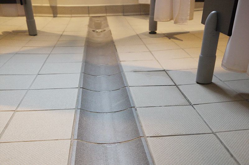 Lowered flooring inside a Private Secondary School washroom in Horsham.