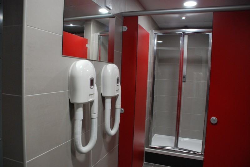 Junction Sports Centre Gym shower cubicle and hair dryers.