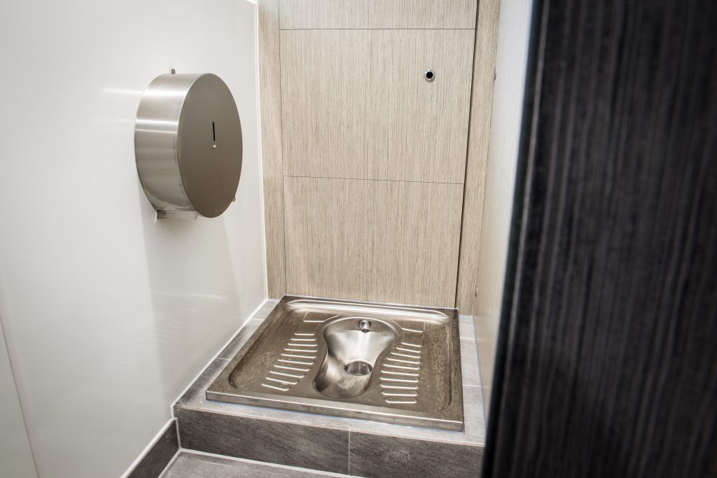Toilet cubicle with a floor squat-toilet.